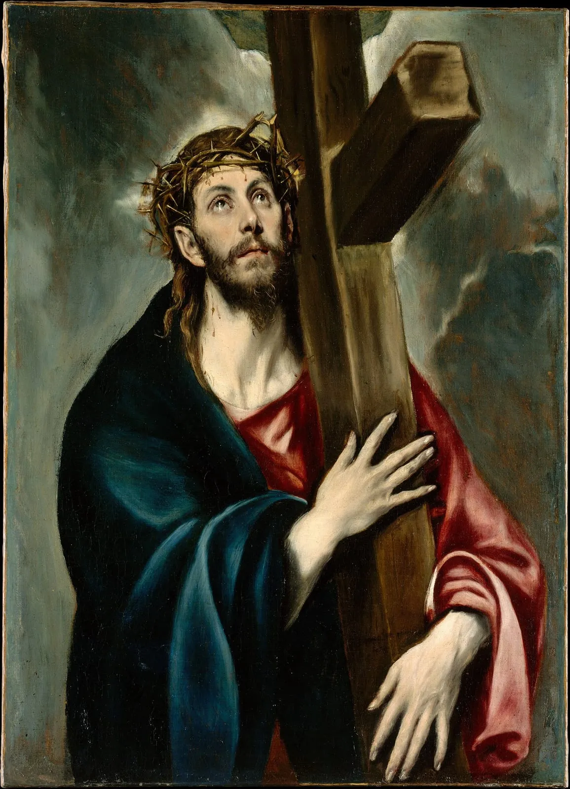 Jezus w cierniowej koronie obejmuje krzyż opierający się na jego ramieniu i patrzy w niebo